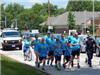 Police Officer in Parade Running with Group of People 2