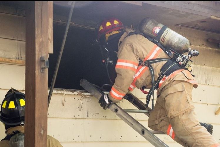 Firefighter Climbing Window