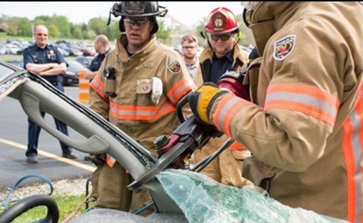 Firefighter Using Tool on Car