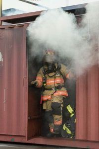 Firefighter Walking out of Smoky Structure