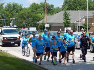 Police Officer in Parade Running with Group of People 2
